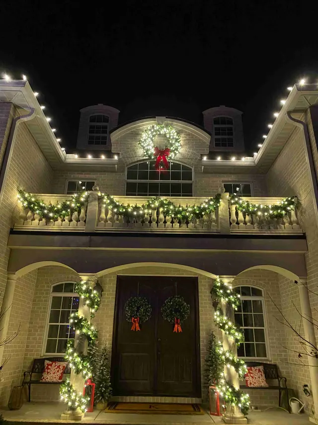 Grand entrance with garland, wreaths, and Christmas lights