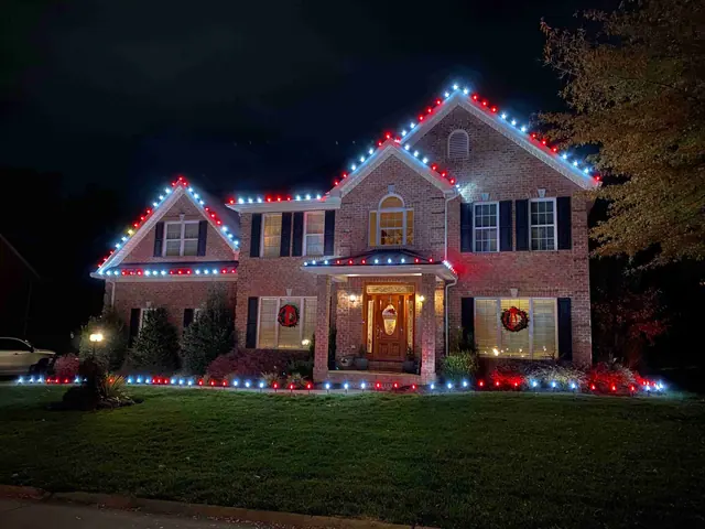 Brick home with red and white Christmas lights and wreaths