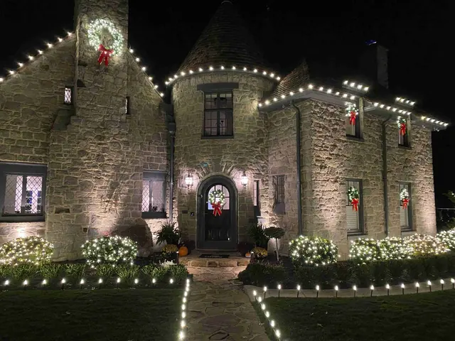 Stone castle-like home with festive Christmas lights and wreaths