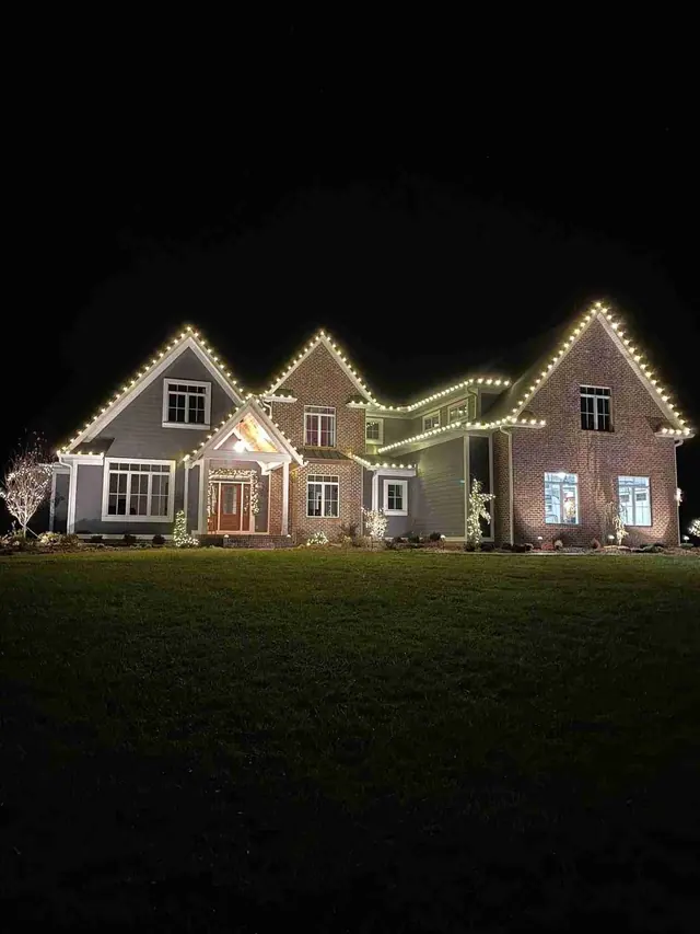 Modern home with extensive white Christmas lighting